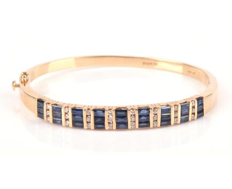 Sapphire and diamond hinged bangle, with alternating vertical rows of baguette cut sapphires and round brilliant cut diamonds