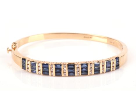 Sapphire and diamond hinged bangle, with alternating vertical rows of baguette cut sapphires and round brilliant cut diamonds