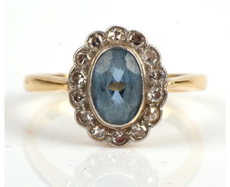 An aquamarine and single cut diamond oval cluster ring, in yellow and white metal stamped "18CT", ring size L.Condition Repor