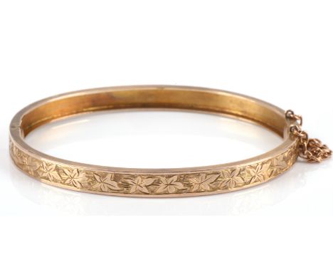 Victorian hinged bangle in yellow metal tested as 9 ct gold, with engraved leaf detailing, hand engraved to the side "Portche