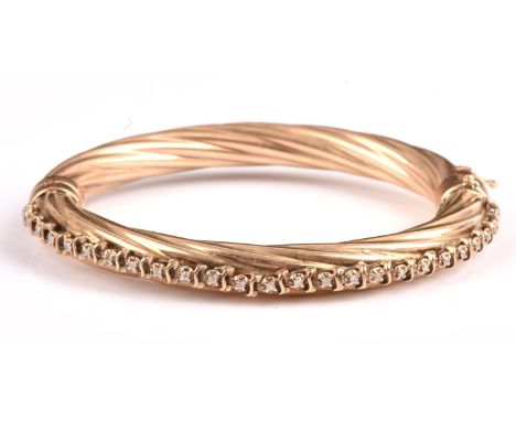 A diamond set bangle, 8mm rope design band, set with twenty-five round brilliant cut diamonds to one half of the hoop, mounte