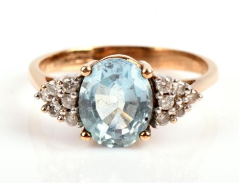 Topaz and diamond ring, oval cut blue topaz measuring 8.95 x 6.18mm, with six round brilliant cut diamonds to each side, moun