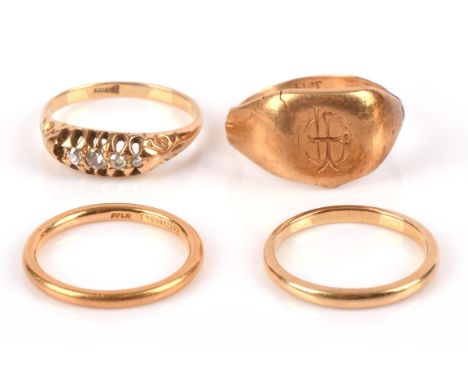 Four gold rings, including a diamond ring stamped "18CT" with one missing diamond, ring size K, a plain band stamped "18CT" w