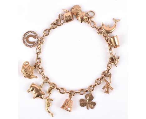 A charm bracelet in 9 ct yellow gold hallmarked Birmingham 1994, bolt ring clasp with a "375" stamp, with twelve charms, most