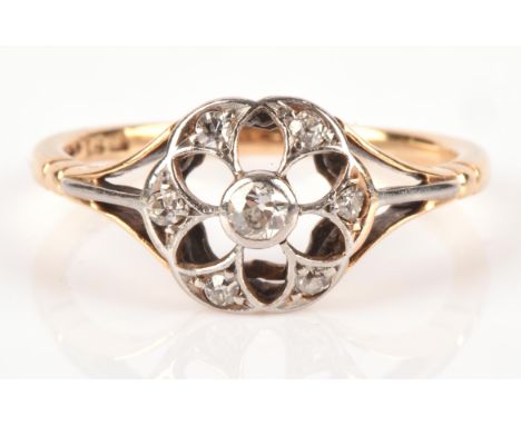 Edwardian diamond floral ring, mount stamped 18 ct, with one old cut diamond and six rose cut diamonds, ring size approximate