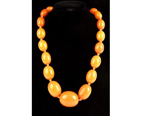 1920's graduated oval amber beads, strung with knots, with a gold plated bolt ring clasp, measuring 92 cm in length, largest 