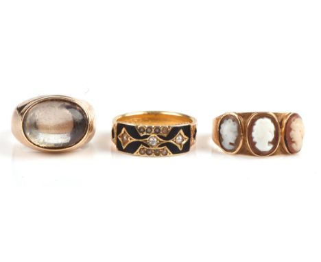 Three rings, including a mourning ring set with an old cut diamond, seed pearls, enamel and hair work, in 15 ct, size K toget