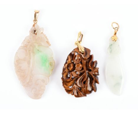 A carved jade pendant, depicting vine and plum, 7 x 3.2cm, with another smaller jade pendant and a carved floral tigers eye p