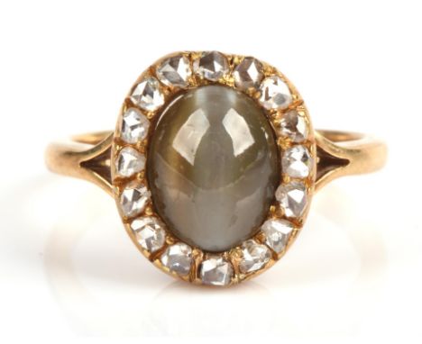 A Chrysoberyl and rose cut diamond oval cluster ring, mounted in yellow metal stamped "18CT", ring size O.Condition Report:  