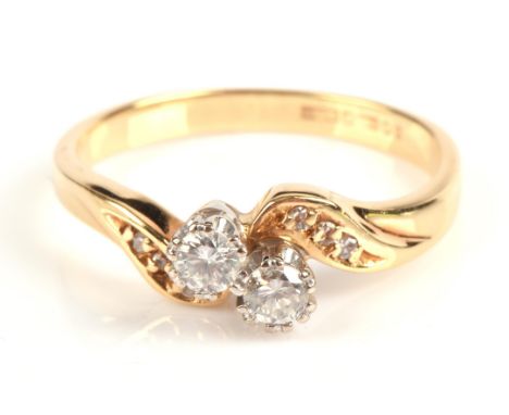 Two stone diamond twist ring, two round brilliant cut diamonds weighing an estimated 0.10 carat each, set in 18 ct gold, hall