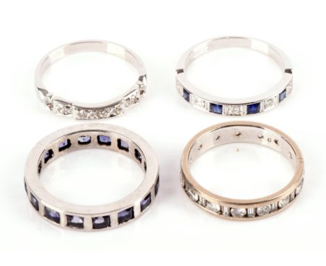 Four eternity rings in white metal stamped for 18 ct gold, the tanzanite full eternity ring unmarked but tested as 18 ct gold