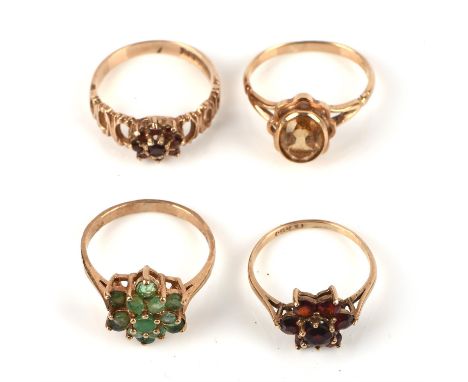 Four gem set rings, including an emerald cluster ring, size N, two garnet cluster rings, sizes K1/2 and M, and a citrine ring