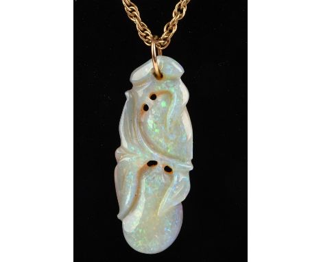 Opal carved pendant, depicting plums on a vine, 3.7 x 1.4cm, on fancy double link chain, stamped 9 ct, measuring 56 cm in len