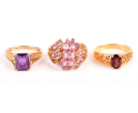 A single stone garnet ring, size N, a pink sapphire cluster ring, size N and a single stone amethyst ring, size N, all in 9 c