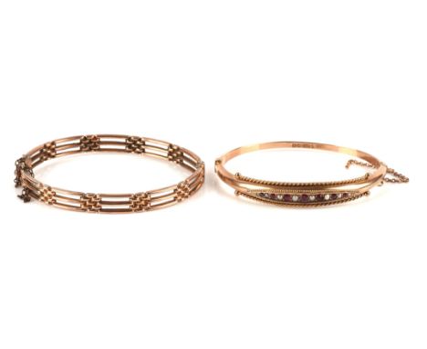 Two gold bangles, including a gate style hinged bangle and a garnet and pearl hinged bangle, both in 9 ctCondition Report:  G