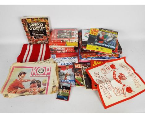 A collection of publications and videos relating to Liverpool Football Club and a scarf.