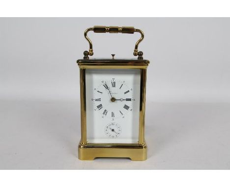 A good French brass and glass Corniche styled case striking carriage clock with alarm, white enamel dial signed Eurotime with