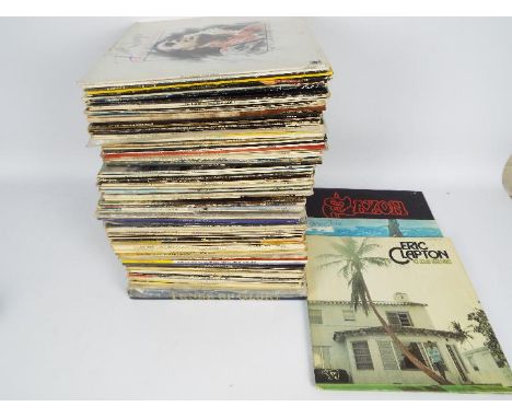 A box of 12" vinyl records to include Donovan, The Beach Boys, Elton John, Eric Clapton, Status Quo, Michael Jackson and simi