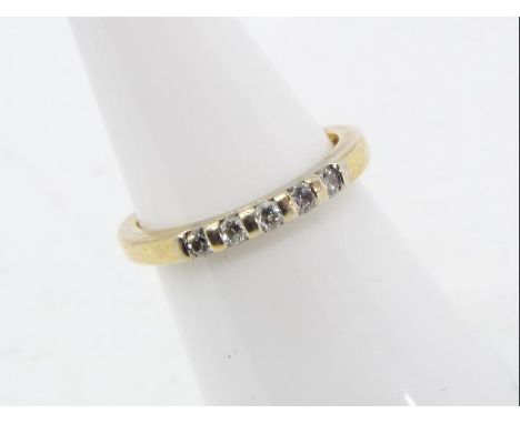 A yellow gold ring marked 9K (9 carat gold) set with five 5-point stones, size K+½, approx 1.95 gm