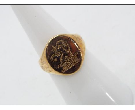 A 9 carat gold signet ring with elephant and crown crest, Birmingham hallmark, size J, approx 5.53 gm