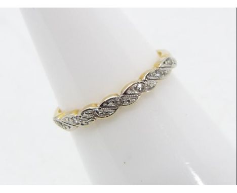 An 18 carat yellow gold and platinum ring set with seven small diamonds, Birmingham hallmark, size M, approx 1.83 gm (all in)