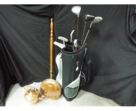 Golfing - a modern golf bag containing eight golf club to include Mercury, Bomber, similar and a copper bed warmer and a copp