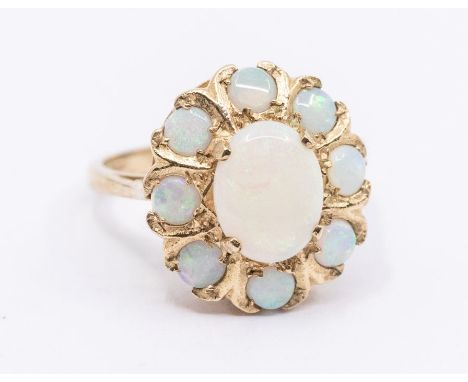 An opal and 9ct gold cluster ring, set with an oval opal within a border of round opals, size M, total gross weight approx 3.