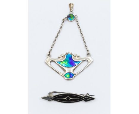 Charles Horner- a silver and enamel pendant, comprising sinuous curves and swirls of open work silver inset with blue and gre