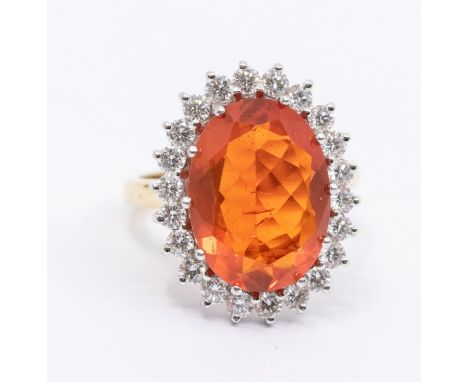 A fire opal and diamond 18ct gold cluster ring, set with an oval opal approx 11 x 15mm, within a border of brilliant cut diam