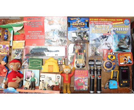 A collection of assorted curios to include: Wallace and Gromit, Harry Potter, Star Wars Lightsabers, ET, Doctor Who and other