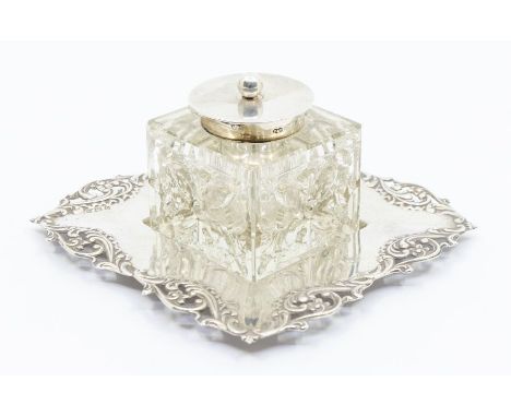 An Edwardian silver mounted glass inkwell incised with floral decoration, plain circular collar and cover together with shape