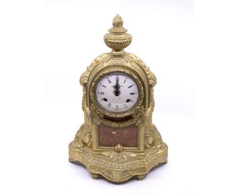 An Italian brass mantel clock with two-train movement striking on two bells. 4" enamel dial. Case cast with torch on top and 