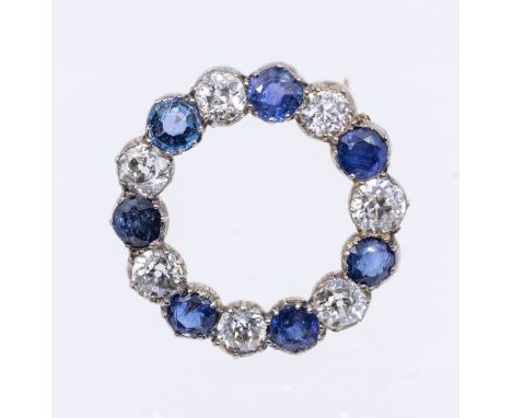 An early 20th century sapphire and diamond circular gold brooch, open form comprising alternate round old cut and round cut s