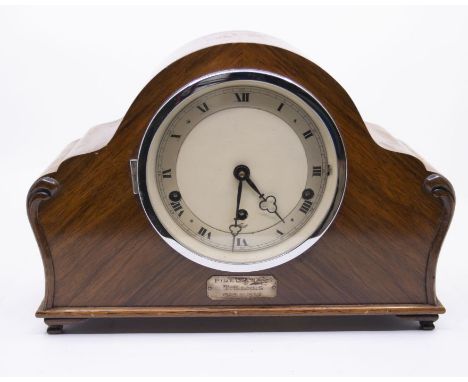 An Elliott Pirelli Ltd presentation mantel clock with three-train movement chiming on rods. Clock with presentation plate: 'T