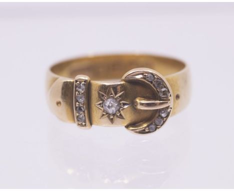 An early 20th century diamond and 18ct gold set buckle ring, width approx 6mm, size O, total gross weight approx 4gms Further