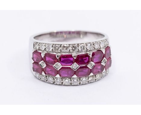 A ruby and diamond 18ct white gold dress ring, comprising a central double row of emerald cut rubies inset with small diamond