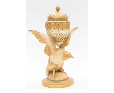 A Royal Worcester lidded pot pourri carried by a bird of prey.Condition: hairline crack to the piercing on the body of the po