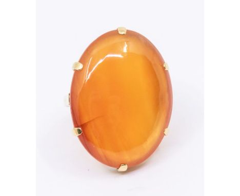 A large carnelian and 18ct gold dress ring, oval claw set stone approx 20 x 28mm, size K, total gross weight approx 11.6gms F