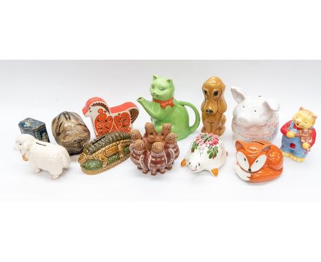A mixed collection of mid to late 20th Century money boxes including tin, wood, ceramic and plastic