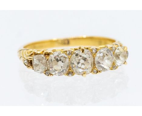 A Victorian diamond and 18ct gold five stone ring comprising five old cushion cut diamonds, with rose cut diamond accents, sc