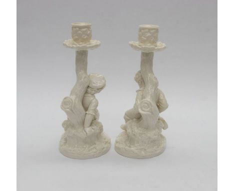 A pair of Royal Worcester Hadley candlesticks of a boy and girl.Condition: good. Total height 9 inches.
