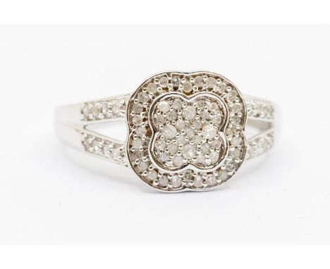 A diamond and white metal ring, floral setting with split shoulders, size L1/2, total gross weight approx 2.4gms Further deta