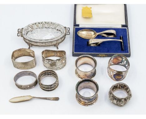 A collection of early 20th Century silver to include: four various napkin rings; a cased Child's pusher and spoon set and a s