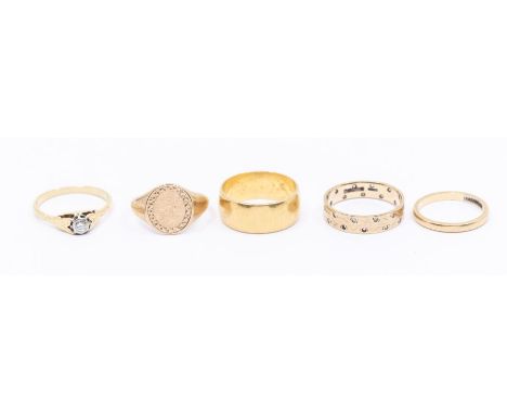 A collection of five gold rings to include a wide 22ct gold band, size O1/2, weight approx 8gms a narrow 18ct gold band, size