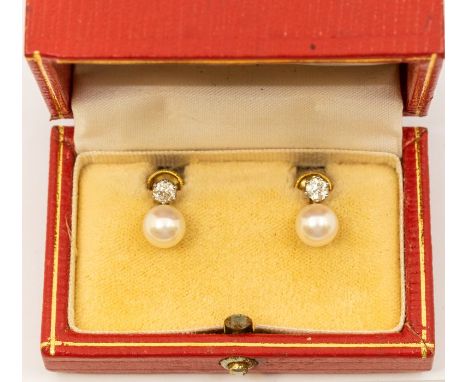 A pair of cultured pearl and diamond 18ct gold earrings, comprising round cultured pearls approx 8mm, claw set to the top wit