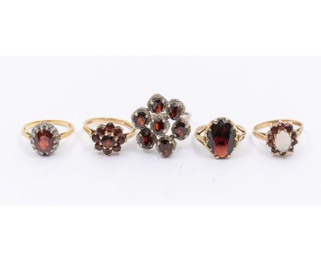 A garnet and diamond 18ct oval cluster ring, size M, total gross weight approx 4.0gms, a 9ct oval cut garnet ring, size L, a 