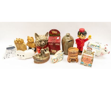 A collection of mixed ceramic wood and tin mid to late 20th Century money boxes including Wade