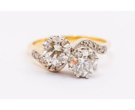 A two stone diamond and 18ct gold cross over ring comprising two round brilliant cut diamonds each approx 0.75ct each, assess