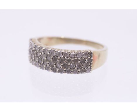 A diamond and 9ct gold set half eternity ring, set to the front with four rows of round brilliant cut diamonds, width approx 