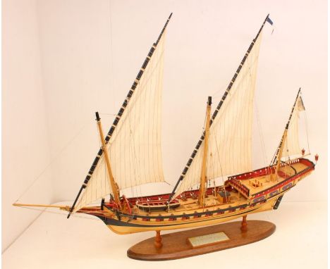 A wooden model ship, 'Indiscret', upon wooden stand. Measuring approx. 100cm length x 78cm height x 18cm depth.